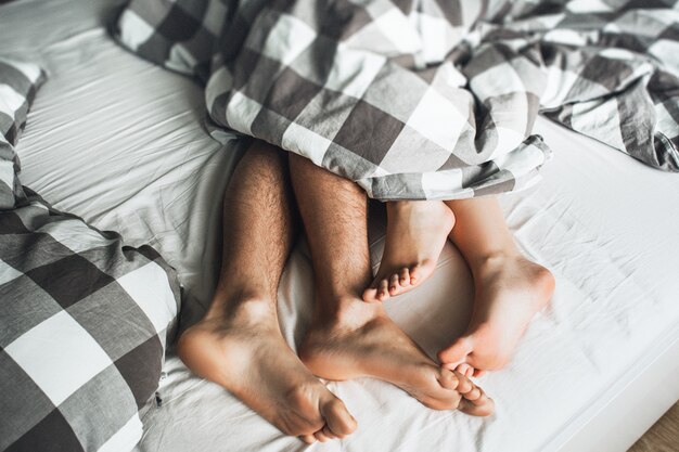 Man And Woman Making Love In Bed